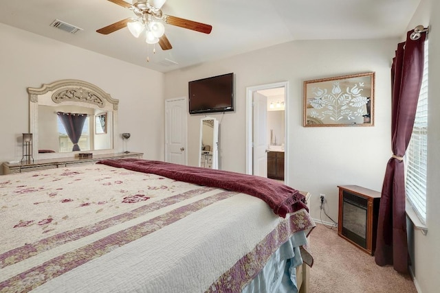 bedroom with light carpet, visible vents, connected bathroom, ceiling fan, and vaulted ceiling