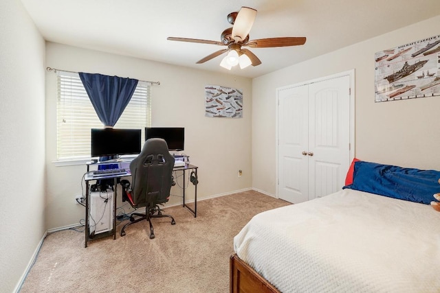 carpeted bedroom with a ceiling fan, baseboards, and a closet