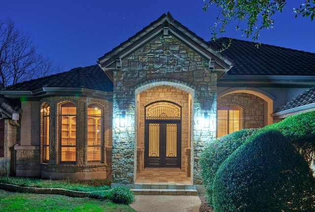 exterior entry at night with stone siding