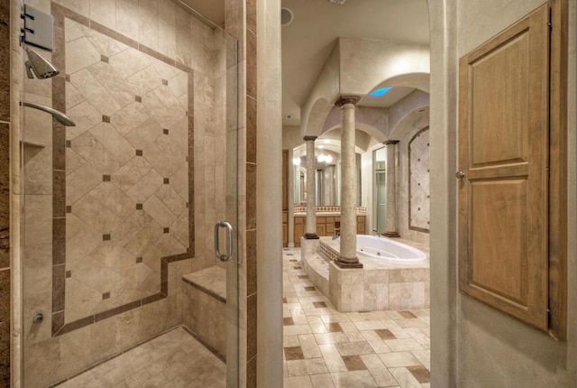 full bath featuring a stall shower, a garden tub, and ornate columns