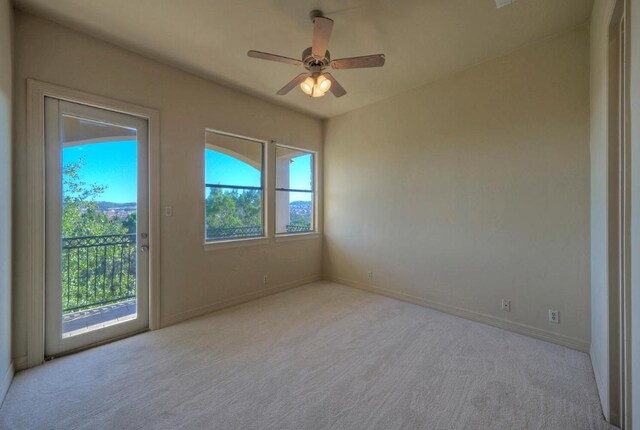 spare room with ceiling fan, baseboards, and carpet flooring