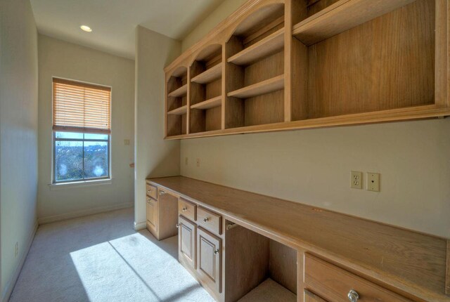 unfurnished office with light colored carpet, built in study area, baseboards, and recessed lighting