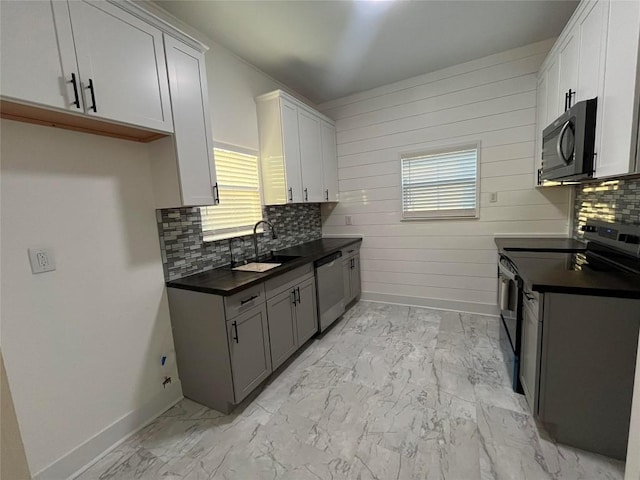 kitchen featuring electric range oven, marble finish floor, stainless steel dishwasher, black microwave, and a sink