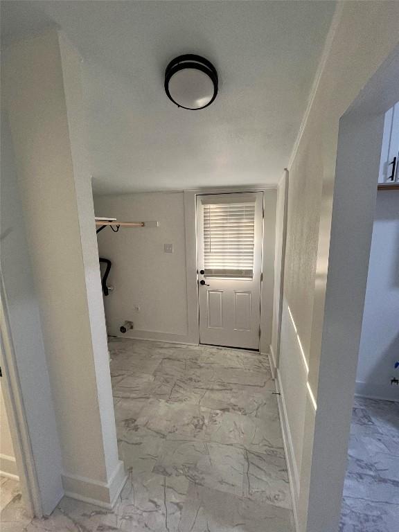 bathroom featuring marble finish floor and baseboards