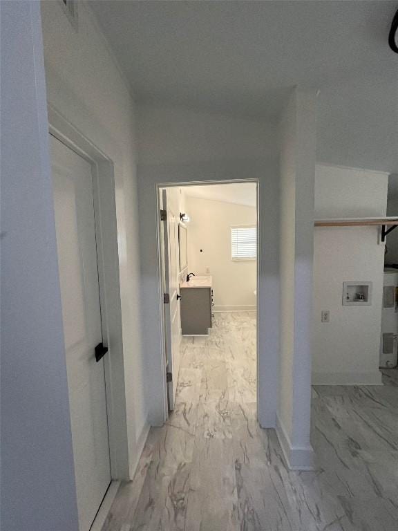 hallway with marble finish floor and baseboards