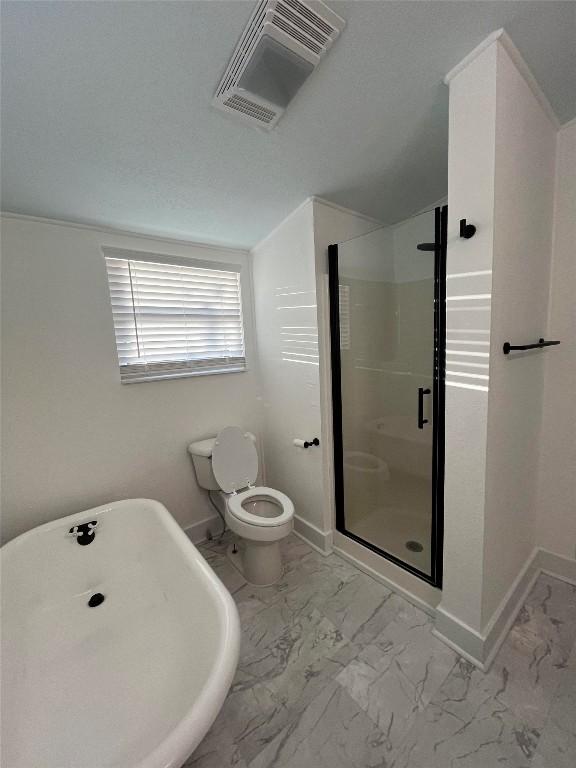 bathroom featuring visible vents, baseboards, toilet, marble finish floor, and a shower stall