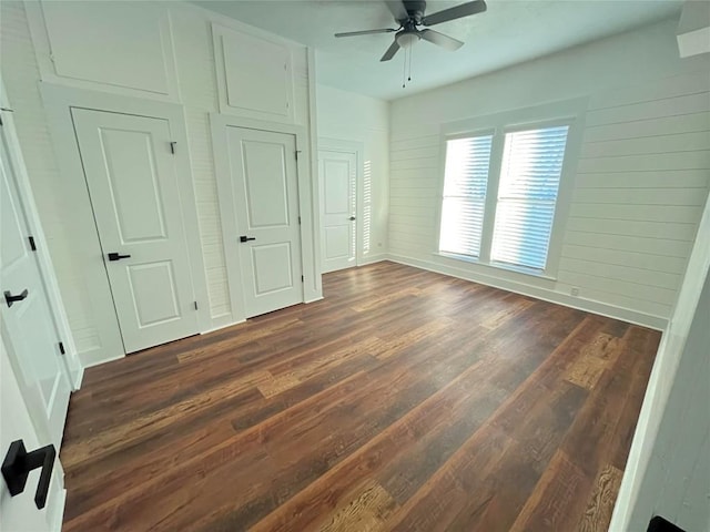 unfurnished bedroom featuring ceiling fan and dark wood finished floors