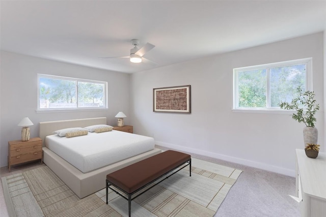 bedroom featuring light carpet, ceiling fan, multiple windows, and baseboards