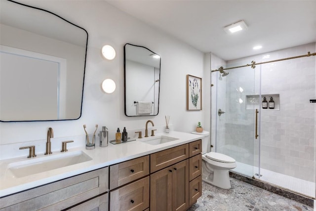 full bath featuring a sink, a shower stall, and toilet