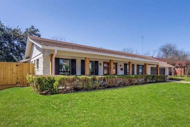 single story home with an attached garage, fence, and a front yard