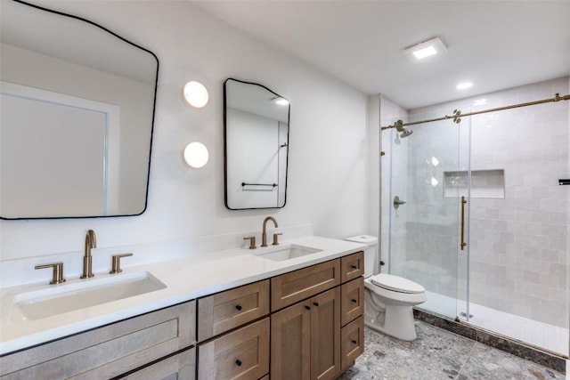 full bath featuring a sink, a shower stall, and toilet