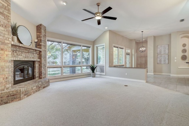 unfurnished living room featuring a brick fireplace, light colored carpet, plenty of natural light, and visible vents