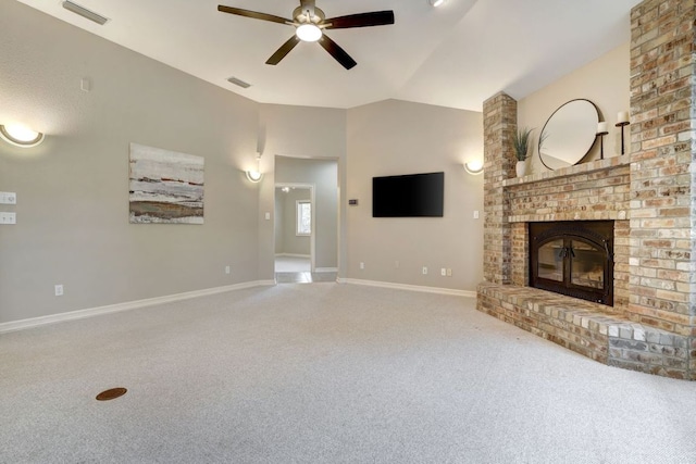 unfurnished living room with visible vents, ceiling fan, vaulted ceiling, carpet flooring, and a brick fireplace