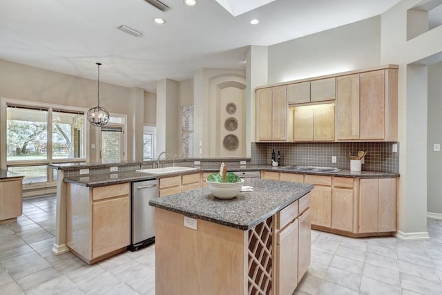 kitchen with a sink, tasteful backsplash, light brown cabinets, and dishwasher