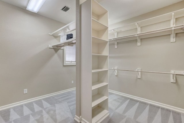 walk in closet with carpet floors and visible vents