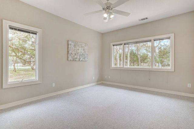 spare room with a ceiling fan, carpet, visible vents, and baseboards