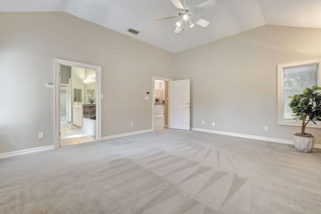 interior space featuring light carpet, baseboards, visible vents, a ceiling fan, and lofted ceiling