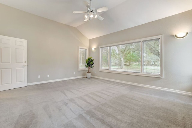 spare room featuring lofted ceiling, carpet floors, ceiling fan, and baseboards