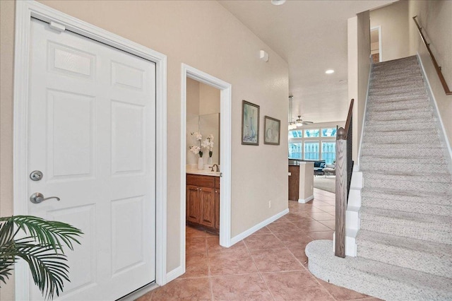 foyer with recessed lighting, stairway, a ceiling fan, light tile patterned flooring, and baseboards