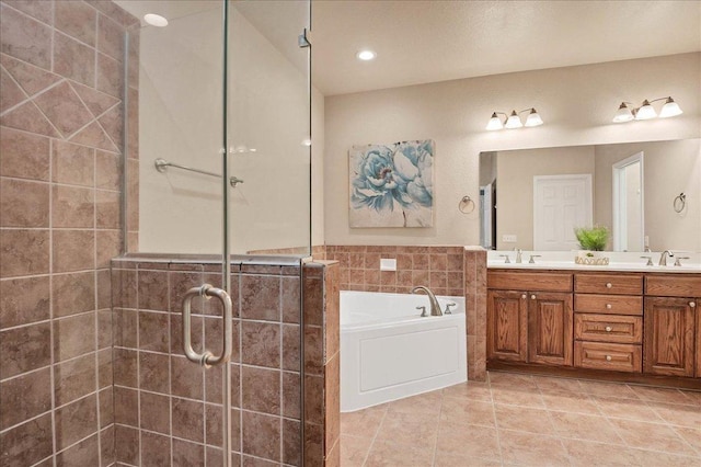 full bathroom featuring double vanity, a stall shower, tile patterned floors, a garden tub, and a sink