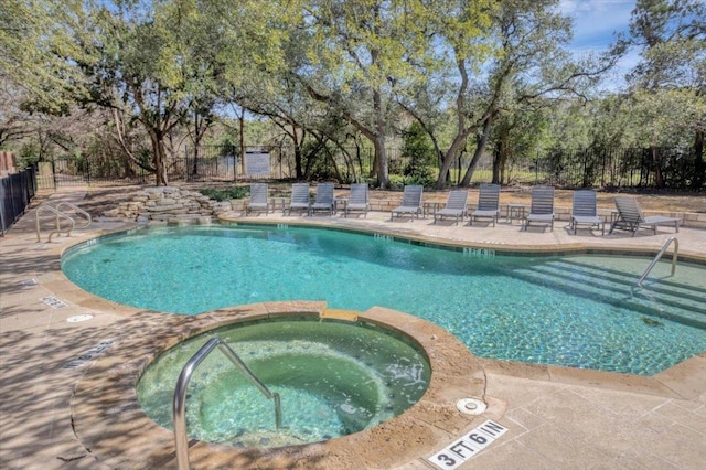 community pool featuring fence, a hot tub, and a patio