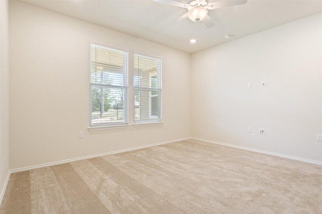 empty room with recessed lighting, light colored carpet, ceiling fan, and baseboards