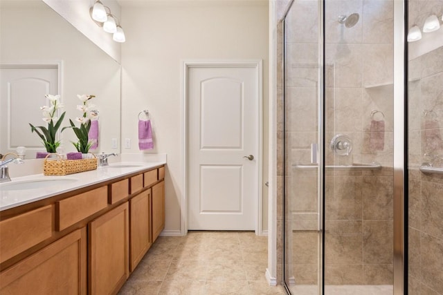 full bathroom with double vanity, a stall shower, a sink, and tile patterned floors