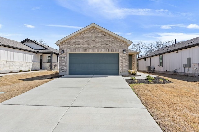 view of front of property featuring a garage, driveway, brick siding, and central AC unit