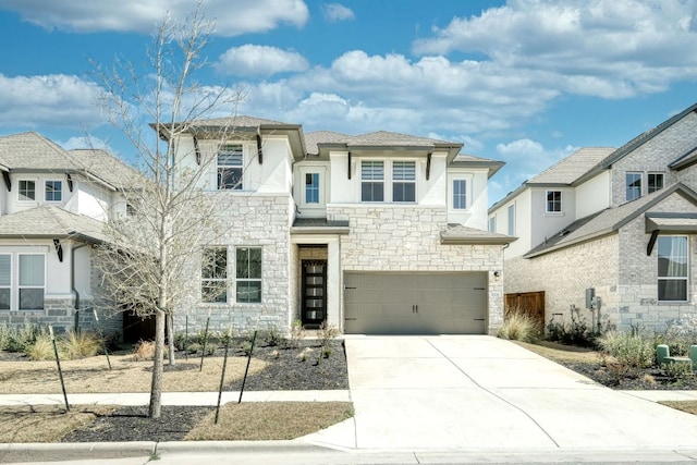 prairie-style house with a garage, stone siding, driveway, and stucco siding