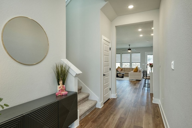 hallway featuring dark wood-style floors, stairway, recessed lighting, and baseboards