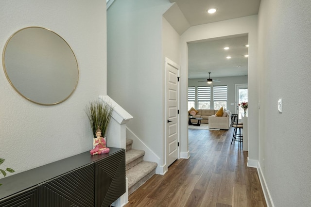 corridor with recessed lighting, baseboards, stairs, and wood finished floors