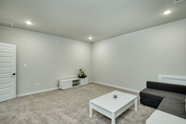 carpeted living area featuring baseboards, recessed lighting, and visible vents