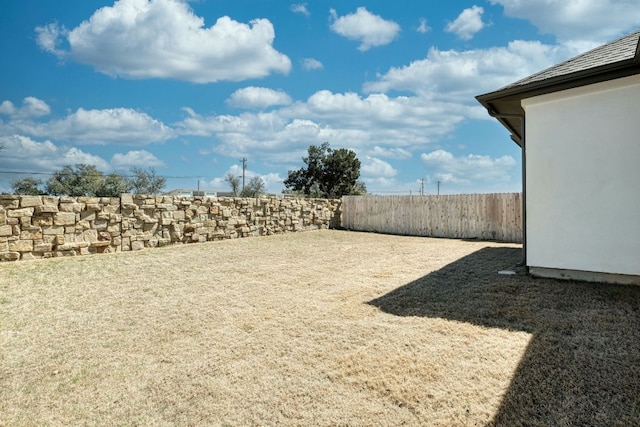 view of yard with a fenced backyard