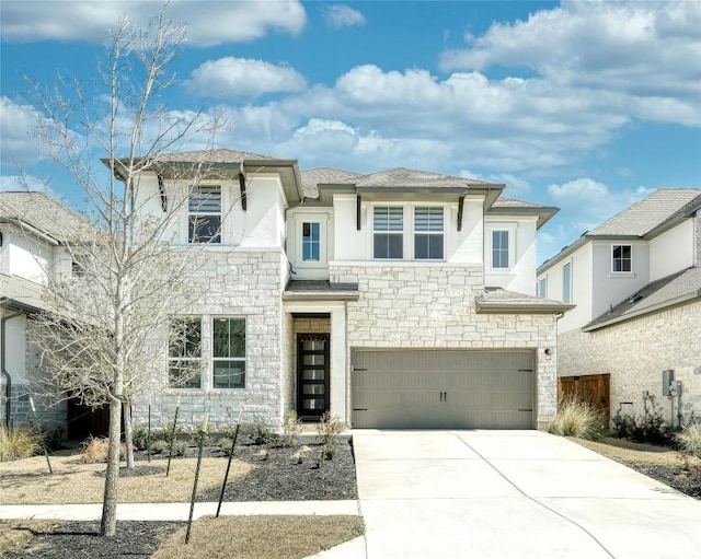 view of front of house with fence, an attached garage, stone siding, stucco siding, and driveway