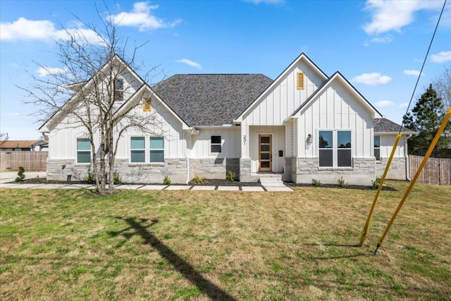 view of front facade with stone siding, board and batten siding, and fence