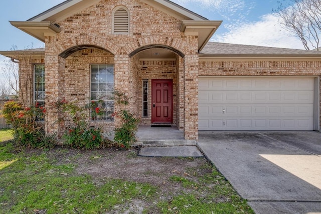 view of front of house featuring a garage, concrete driveway, brick siding, and a shingled roof