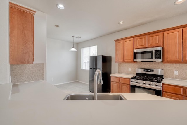 kitchen featuring appliances with stainless steel finishes, decorative backsplash, light countertops, and recessed lighting