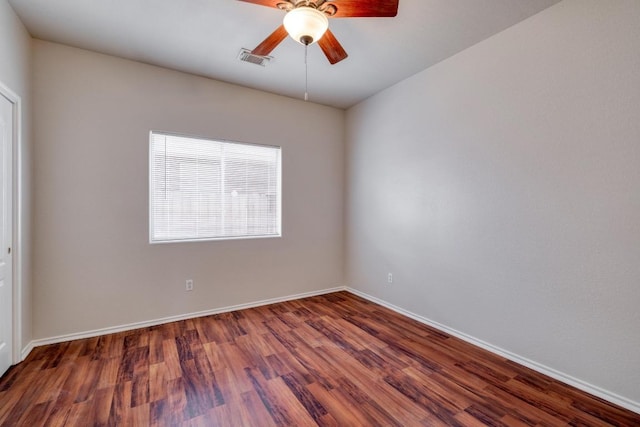 empty room featuring baseboards, wood finished floors, visible vents, and a ceiling fan