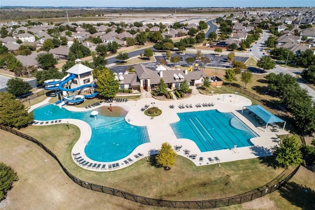 pool featuring a patio area, a residential view, and a water slide