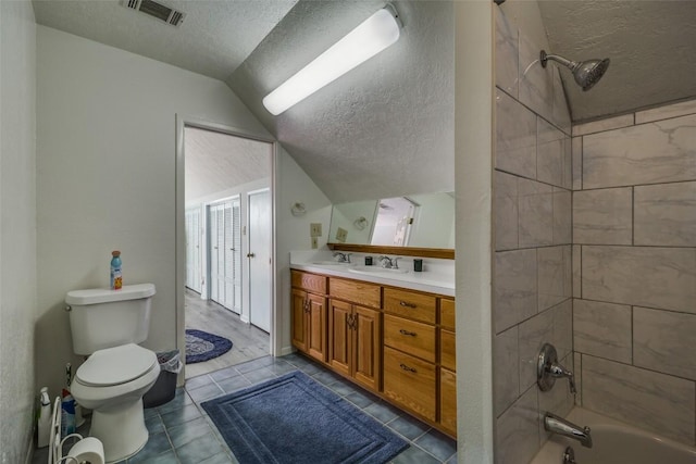 bathroom featuring lofted ceiling, visible vents, toilet, a textured ceiling, and vanity