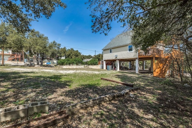 view of yard featuring a wooden deck and stairs