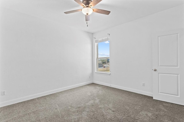 empty room with carpet, ceiling fan, and baseboards