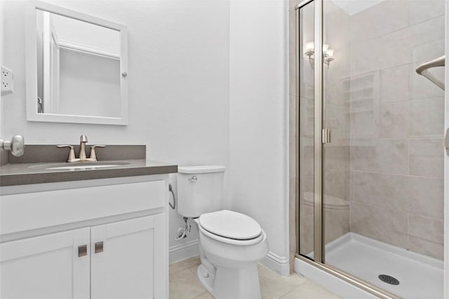 full bathroom with a stall shower, baseboards, toilet, tile patterned flooring, and vanity