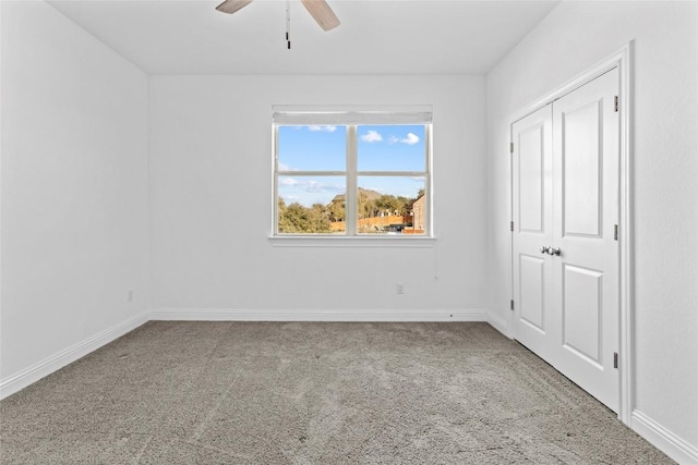 unfurnished bedroom with a ceiling fan, carpet, and baseboards