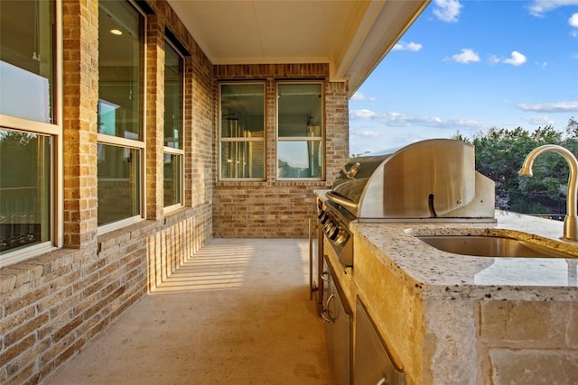 balcony featuring grilling area, an outdoor kitchen, and a sink