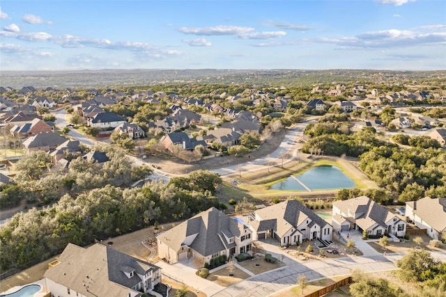 drone / aerial view featuring a residential view and a water view