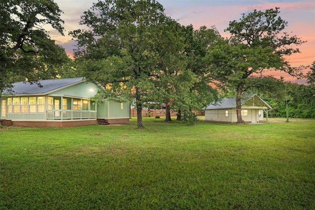 yard at dusk featuring an outbuilding