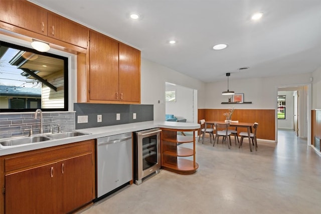 kitchen featuring finished concrete flooring, beverage cooler, a sink, light countertops, and dishwasher