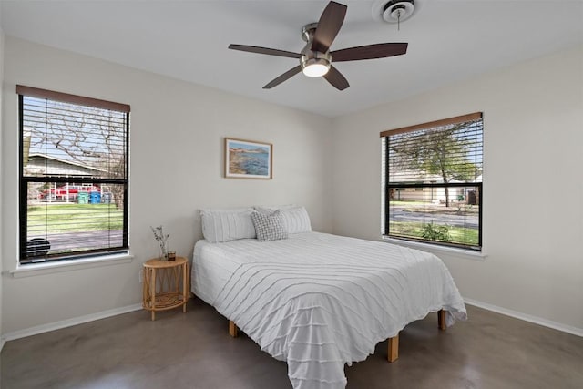 bedroom with baseboards, visible vents, concrete flooring, and ceiling fan