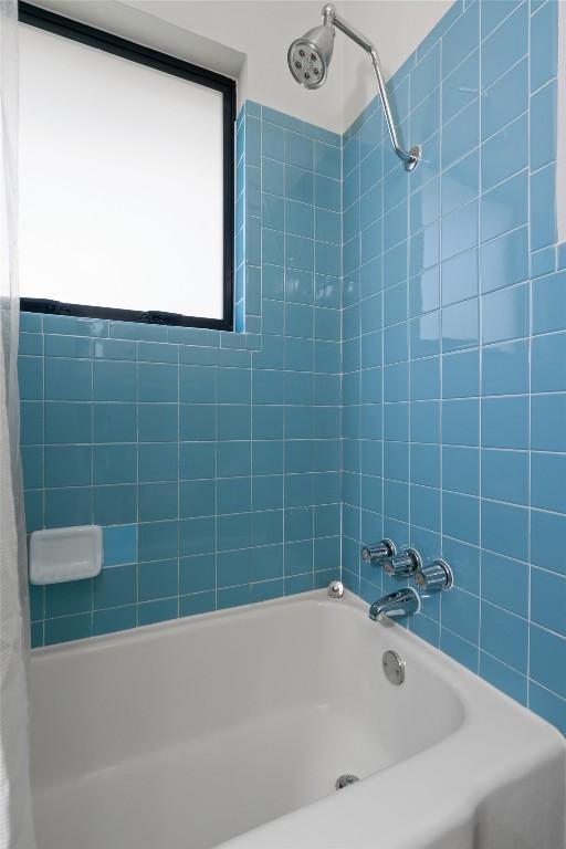 bathroom with shower / bathtub combination with curtain